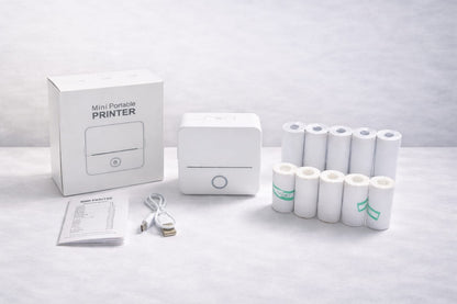 Package includes:

Printer
Charger
User manual
5 rolls sticker paper
5 rolls white paper